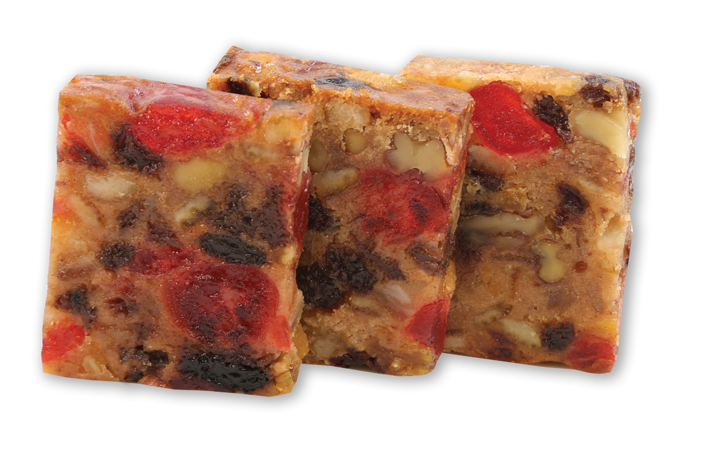 Three slices of Claxton Fruit Cake packed with candied cherries, raisins and pecans.