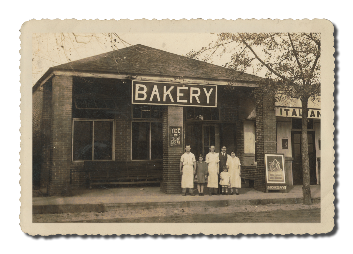 Vintage photo of the original Claxton Bakery storefront with staff standing in front.