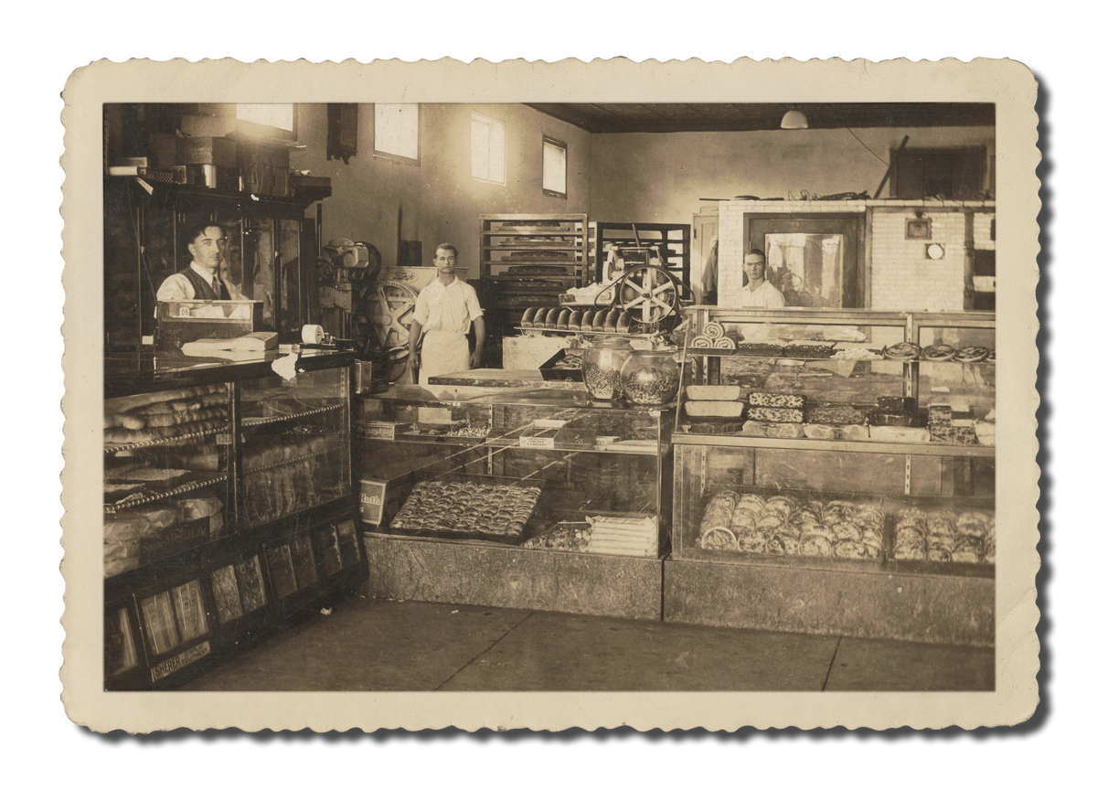 Vintage photo inside the early Claxton Bakery with display cases of baked goods.